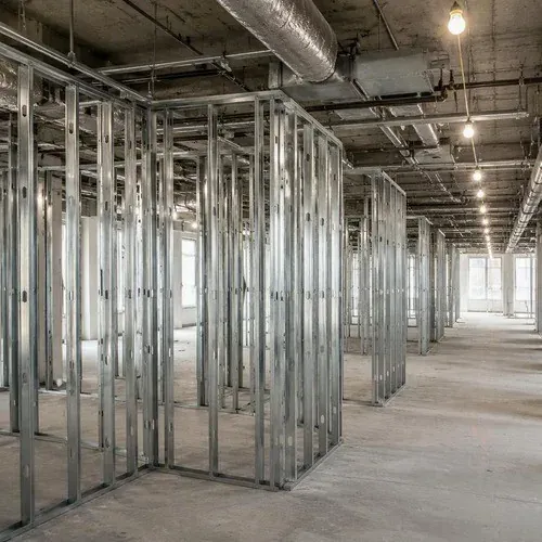 Metal stud framing laid out across an open commercial office floor ahead of boarding