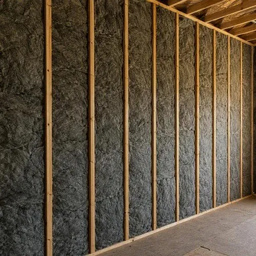 Sound insulation batts packed between interior wall studs to absorb airborne noise