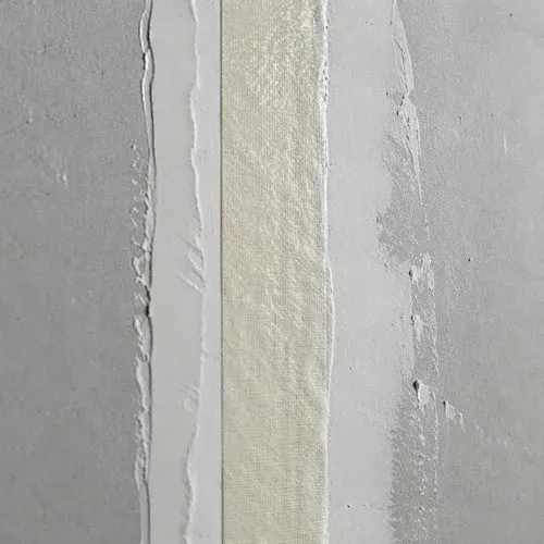 Paper tape bedded over a drywall seam in the first coat of compound