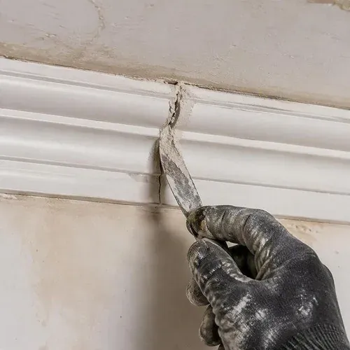 Filling and working the joint where the new cast section meets the original cornice