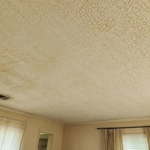 Dated popcorn ceiling in a post-war St. Catharines living room, due for removal