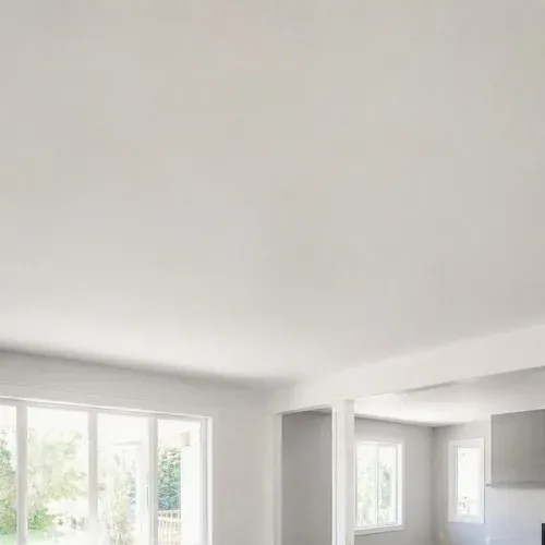 Smooth white ceiling after popcorn removal, skimmed flat and left paint-ready