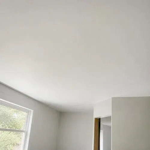 Smooth finished ceiling with the filled pot light holes completely invisible