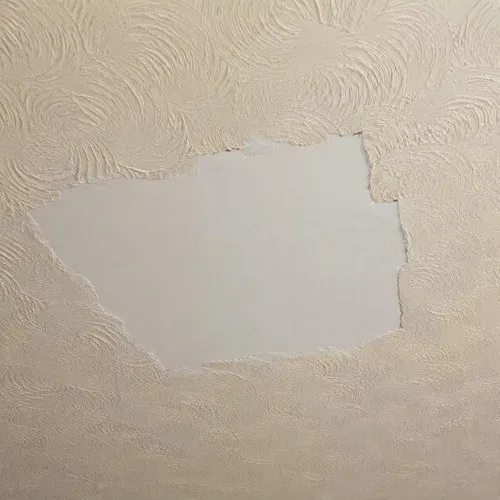 Swirl textured ceiling section awaiting a blend, with the original pattern still readable